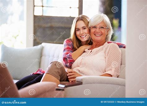 Grandmother With Adult Granddaughter Relaxing On Sofa Stock Image Image Of Home Camera 59723323