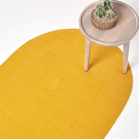 Homescapes Mustard Yellow Handmade Braided Oval Rug For Bedroom