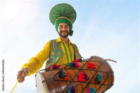 Portrait Of Sikh Man Playing Drum During Baisakhi Celebration Stock