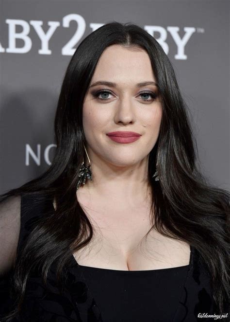 A Woman With Long Black Hair Wearing A Black Dress And Red Lipstick Is