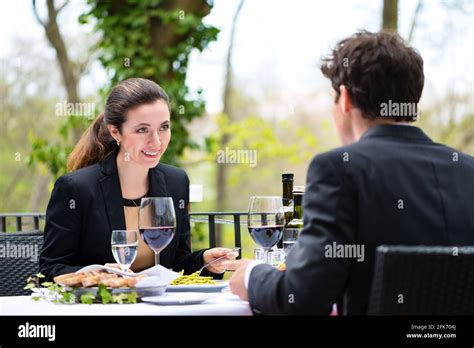 Businesspeople Having Business Lunch Outside On The Terrace In A Fine