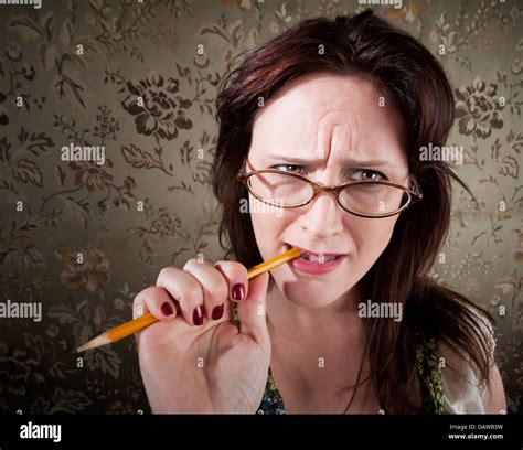 Nervous Woman Chewing On A Pencil Stock Photo Alamy