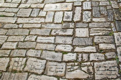 The Ancient Cobblestone Pavement Close Up Background Of Natural Stone