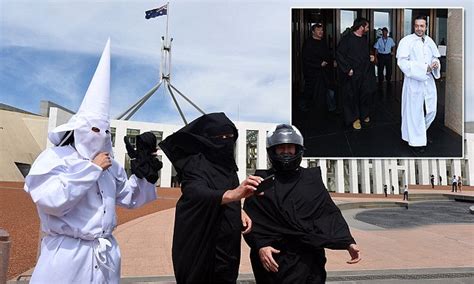 Men In Ku Klux Klan Outfit Burqa And Helmet Stage Protest At