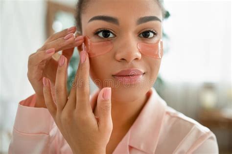 Facial Skincare African American Lady Applying Cosmetic Patches Under Eyes Moisturizing Skin