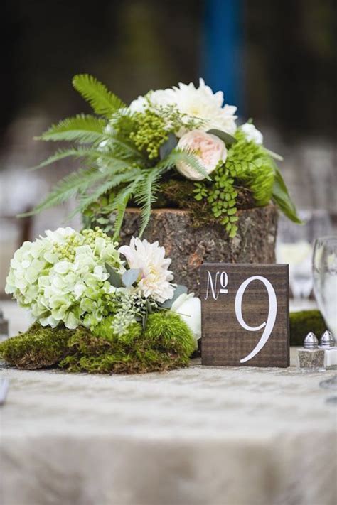 A woodland wedding tablescape with a moss tablecloth, greenery, candles in gold candleholders and an elegant clock. Romantic Enchanted Forest Wedding Ideas: Create The Dream!