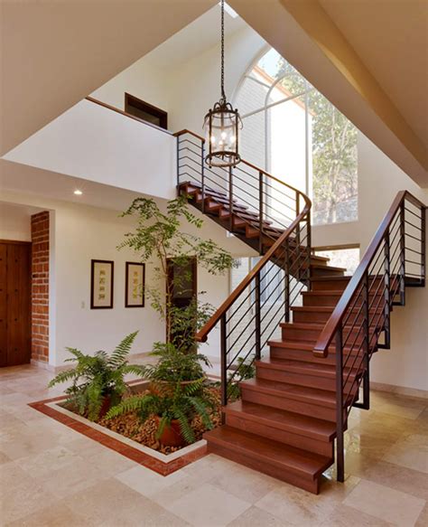 A Staircase In A House With Potted Plants
