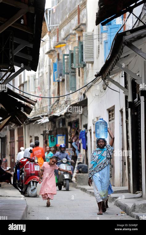 People In A Narrow Street In Stonetown Zanzibar Tanzania Stock Photo