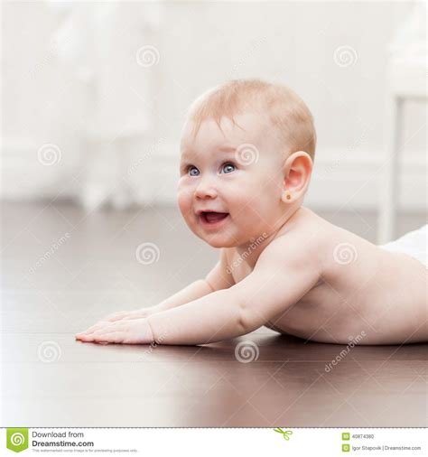 Read more about milestones in 7th month of your baby. Happy Seven Month Old Baby Girl Crawling On A Hardwood ...