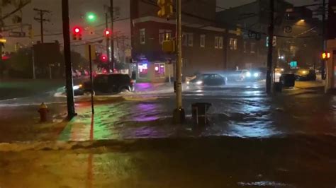 Cars Drive Along Flooded Street In Hoboken