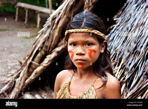 Young Girl Poses Outside Of Her Tribal Village In The Peruvian Amazon Jungle Near Iguitos Peru