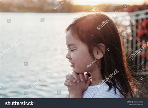 Multicultural Little Girl Praying Alone Sunflare Stock Photo 1302535933