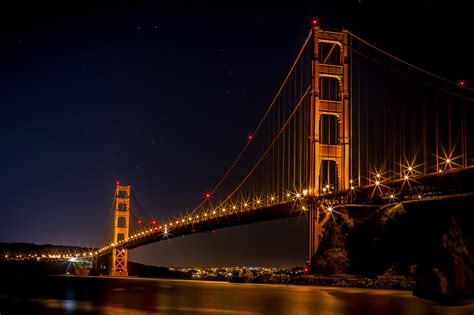 Golden Gate Bridge Over The Bay At Night Illuminated In