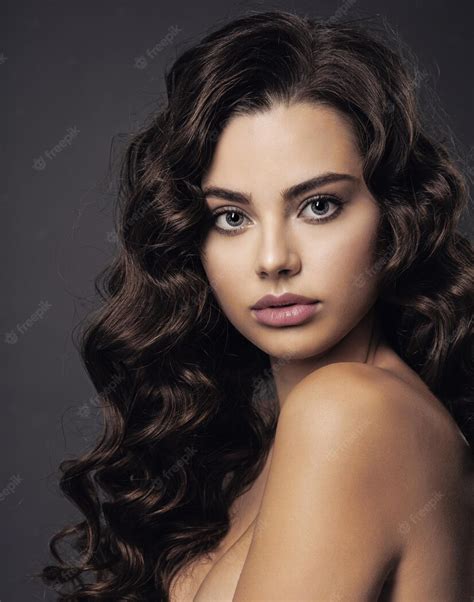 Free Photo Beautiful Young Woman With Long Curly Brown Hair And Smoky