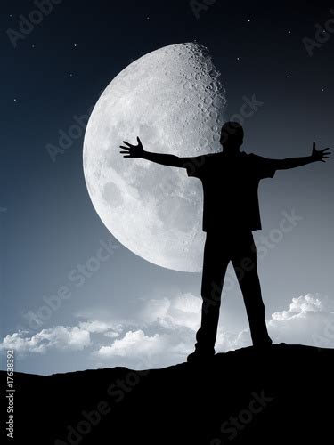 Silhouette Of A Man In Front Of The Moon Stock Photo And Royalty Free