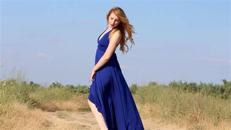 Sensual Girl In A Long Blue Dress Among Nature On A Sunny Day Free