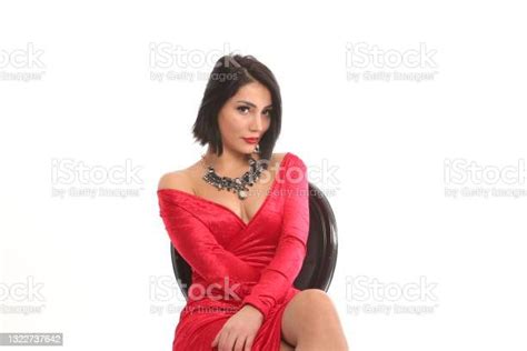 Young Beautiful Hot Woman In Red Dress Front Of White Background Stock