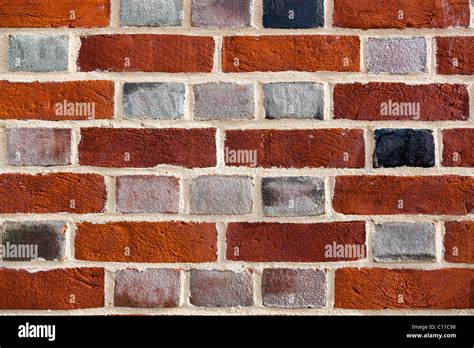 Close Up Of A Brick Wall Showing Multi Coloured Bricks And Light Mortar