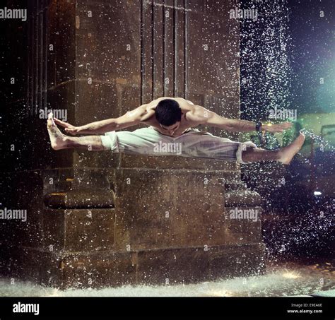 Muscular Guy Jumping And Doing The Splits In Fountain Stock Photo Alamy