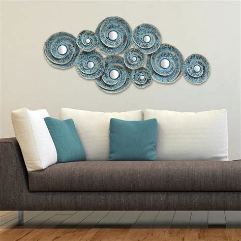 Most wall art comes with wire or slots for nails or pins for hanging. Stratton Home Decor Stratton Home Decor Decorative Waves Metal Wall Decor-S01293 - The Home Depot
