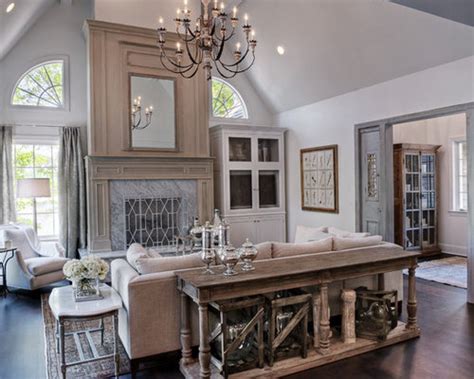 A living room can sometimes feel sectioned off, but a sofa table can act as a welcoming element to guests. Behind Sofa Console Table | Houzz