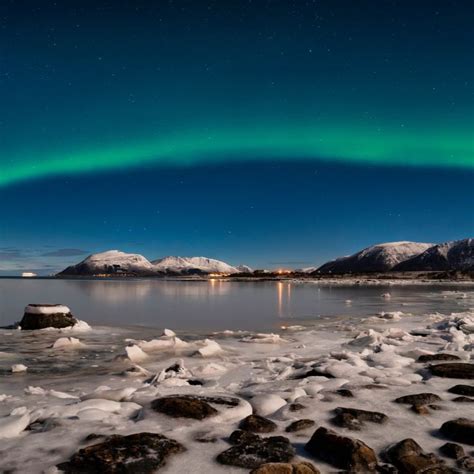 Download Aurora Borealis Snow Covered Stones Mountains Reflection On