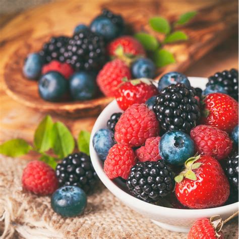 Fresh Berries In A Bowl On Rustic Wooden Background Picture