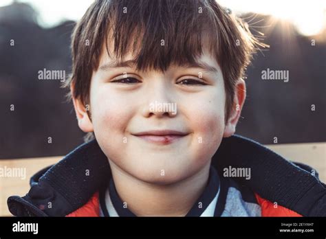 Portrait Of A Cute Little Boy With Bangs Smiling Stock Photo Alamy