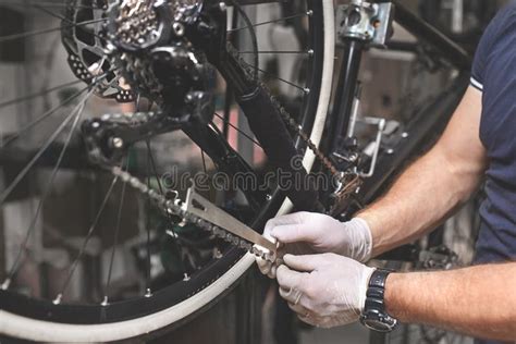 Bicycle Mechanic In A Workshop In The Repair Process Stock Photo