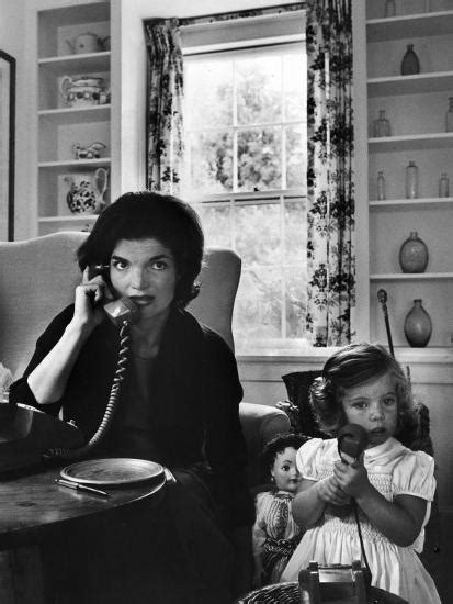 Jackie Kennedy Wife Of Senator John Kennedy Talking On The Telephone As Her Daughter Mimics