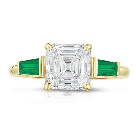 The Asscher Cut Three Stone Ring With Green Emerald Tapered Baguettes