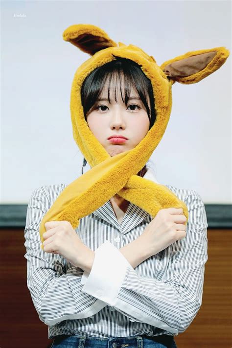 A Woman Wearing A Yellow Bunny Ears Hat And Scarf Over Her Head With