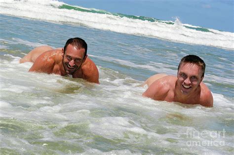 Two Naked Men Playing In The Ocean Photograph By Gunther Allen Fine