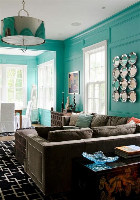 From navy to turquoise, here's how to for a sophisticated feel, go for mid to dark tones of blue on the wall that will really envelop a room. Love turqoise w black silver light & wall decoration | Living room turquoise, Blue living room ...