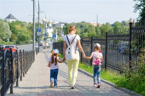 Mother And Two Daughters Are On Sidewalk Along The Road Stock Image Image Of Look Hands 79603993