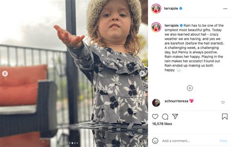 Terra Jolés Daughter Penny Plays In The Rain Wearing A Grey Floral