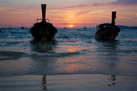 Sunset At Tropical Beach With Traditional Thai Boats Stock Image