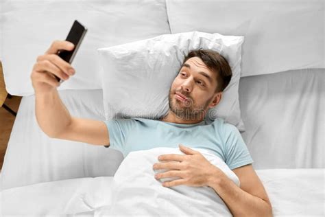 Happy Man Taking Selfie With Smartphone In Bed Stock Image Image Of
