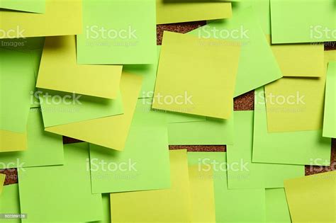 Blank Green And Yellow Sticky Notes On Cork Bulletin Board Stock Photo