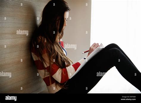 Teenage Girl Writing In Notebook Stock Photo Alamy