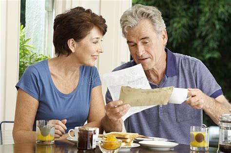 Middle Aged Couple With Bills Over Breakfast Stock Image Image Of