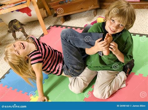 Tickling Her Brother Stock Image 714667