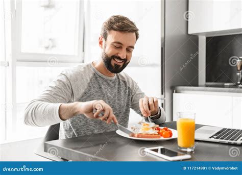 Portrait Of A Handsome Young Man Having Breakfast Stock Image Image