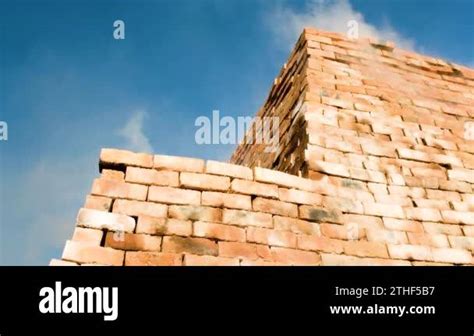 Stacked Clay Bricks Being Fired In Clamp Kiln Smoke And Heat Escaping