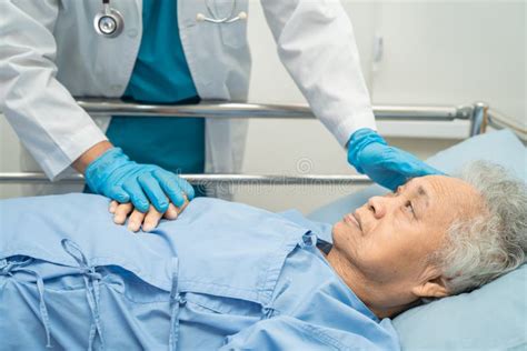 Doctor Checking Senior Or Elderly Old Lady Woman Patient Lie Down In