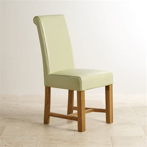 The frame is sturdily constructed with wood and comfortably padded with foam cushioning. Cream Leather Dining Chair with Braced Oak Legs | Dining Room