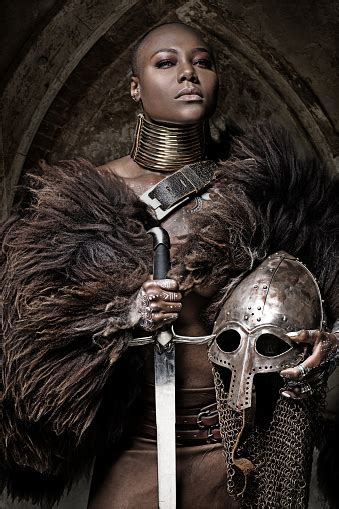 Beautiful Black Warrior Princess Holding A Sword In Studio Shot Stock