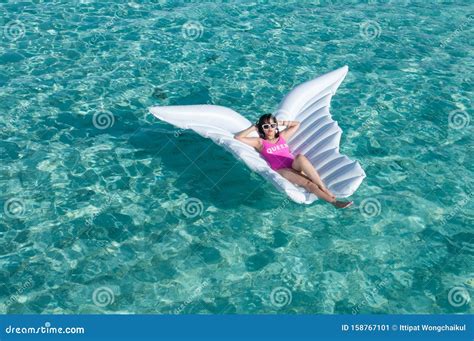 Luxury Summer Vacation Beach Woman Relaxing Lying Down On Inflatable
