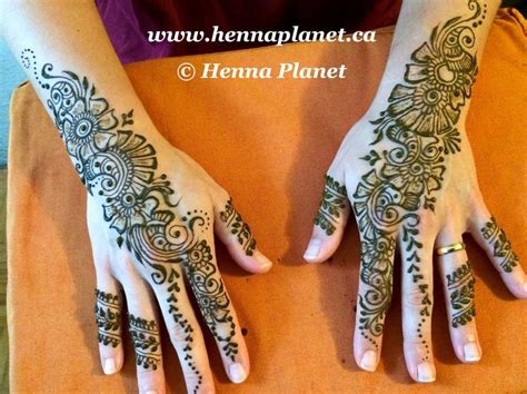 two hands with henna tattoos on them