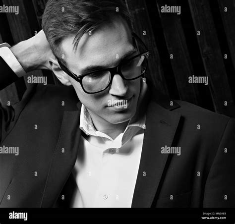 Thinking Business Man Looking Down In Suit And Trendy Eyeglasses On